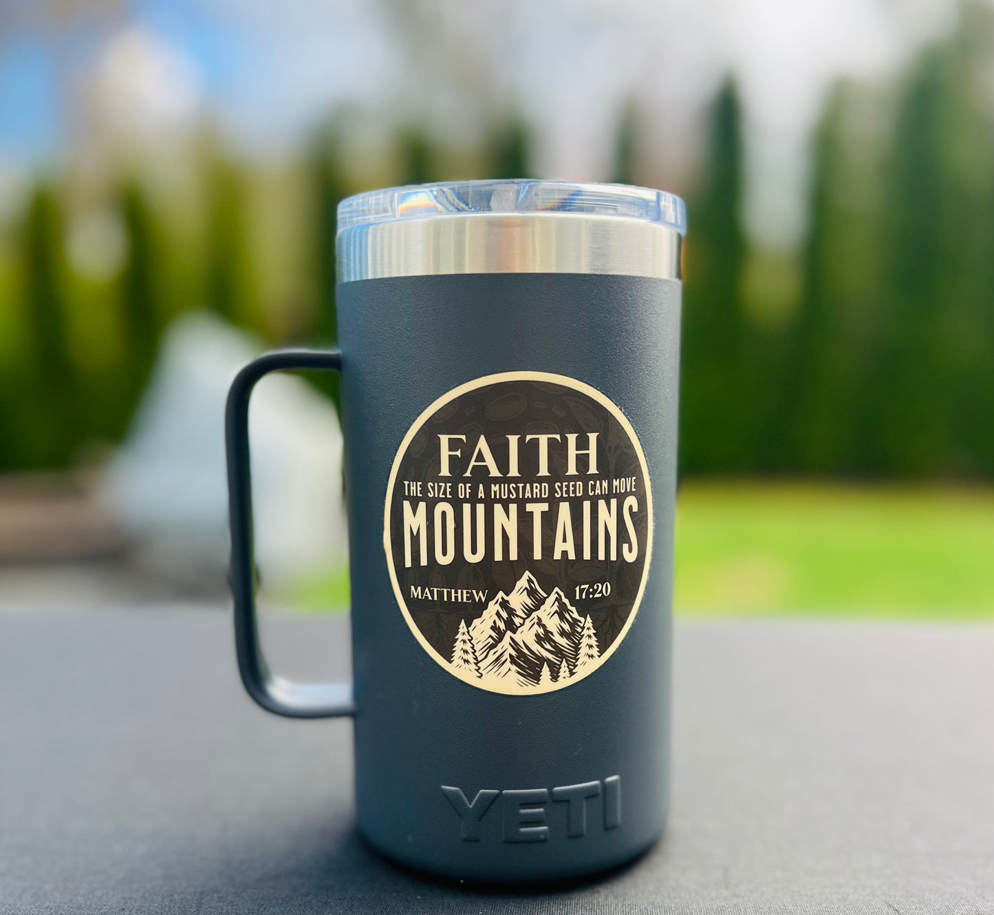 Close-up of 3-inch Faith Can Move Mountains Waterproof Sticker on water bottle