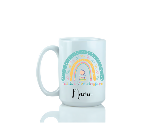 15oz White mug with a colorful design featuring a rainbow, cloud, and text that read teach, love, inspire.