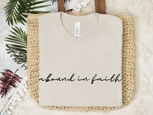 Abound in Faith women’s Christian t-shirt with script font in white