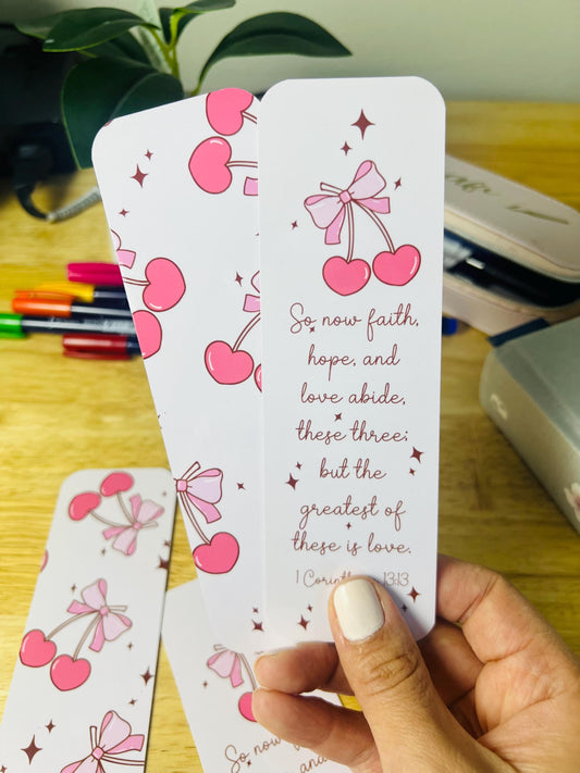 Christian bookmark with pink cherries and bow design featuring 1 Corinthians 13:13 Bible verse about faith, hope, and love