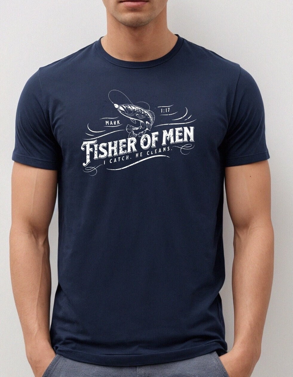 Christian shirt with Fisher of Men phrase and “I catch. He cleans.” text in navy blue t shirt and white text