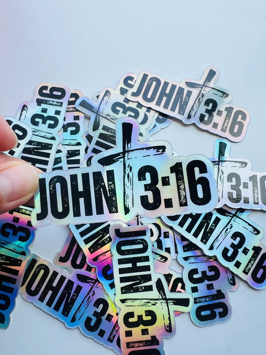 Hand holding a stack of holographic John 3:16 Sticker with bold Bible verse design and cross symbol, ideal for laptops, Bibles, or water bottles