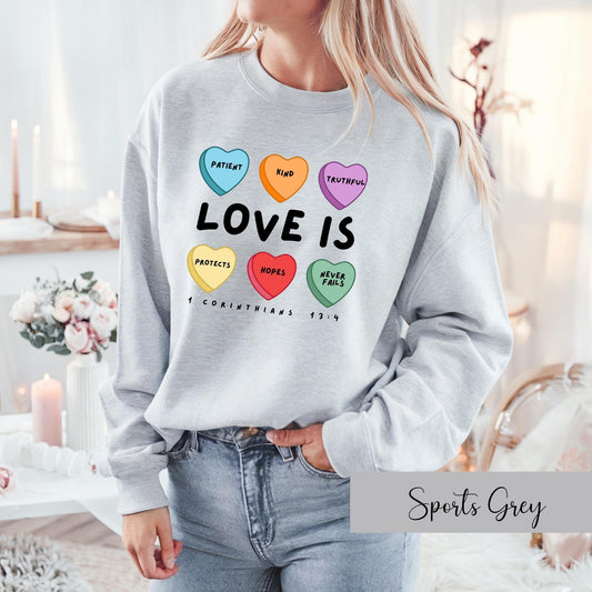 Grey Christian sweatshirt for women with colorful Love Is design based on 1 Corinthians 13:4 Bible verse