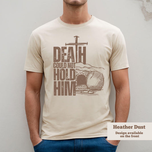 Christian Easter Shirt in heather Dust with cross and tomb graphic that says 'Death Could Not Hold Him'