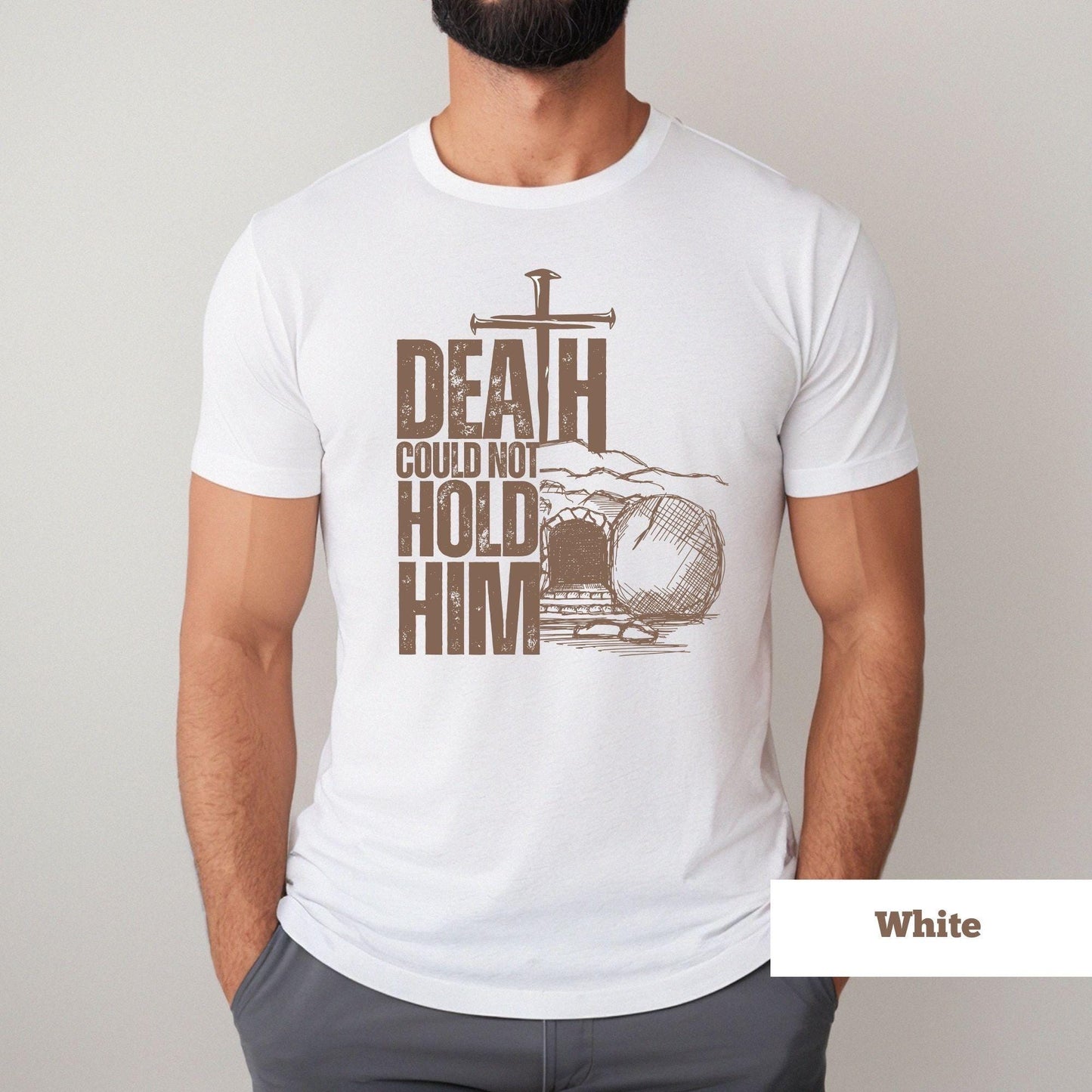 Christian unisex Easter shirt in white with cross and tomb graphic that says 'Death Could Not Hold Him'