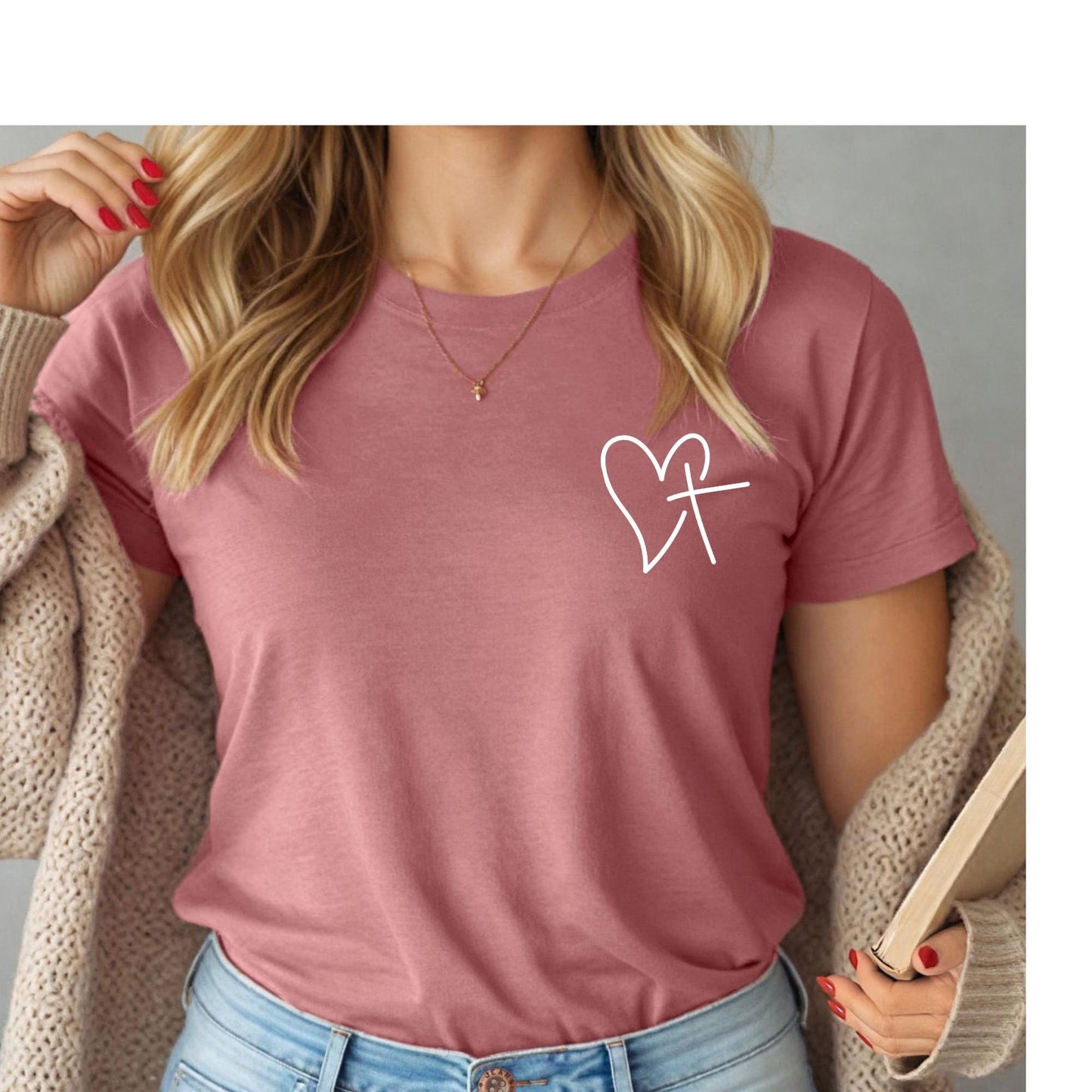 Mauve Christian t-shirt featuring a heart and cross design, worn by a woman, styled with romantic Valentine’s decor – a perfect faith-based gift for women.