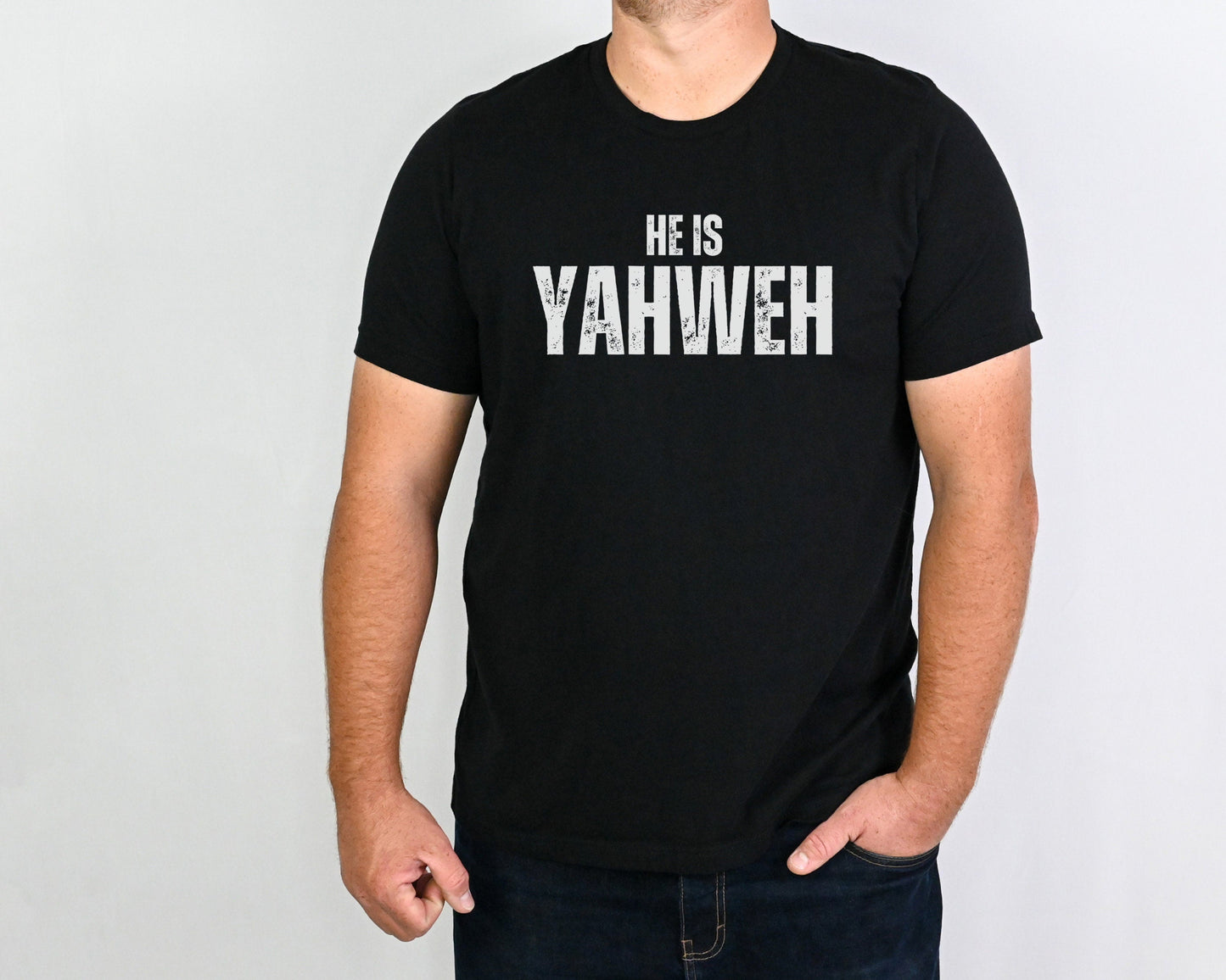 Men wearing He Is Yahweh Shirt – Christian Unisex Tee in black with bold white text