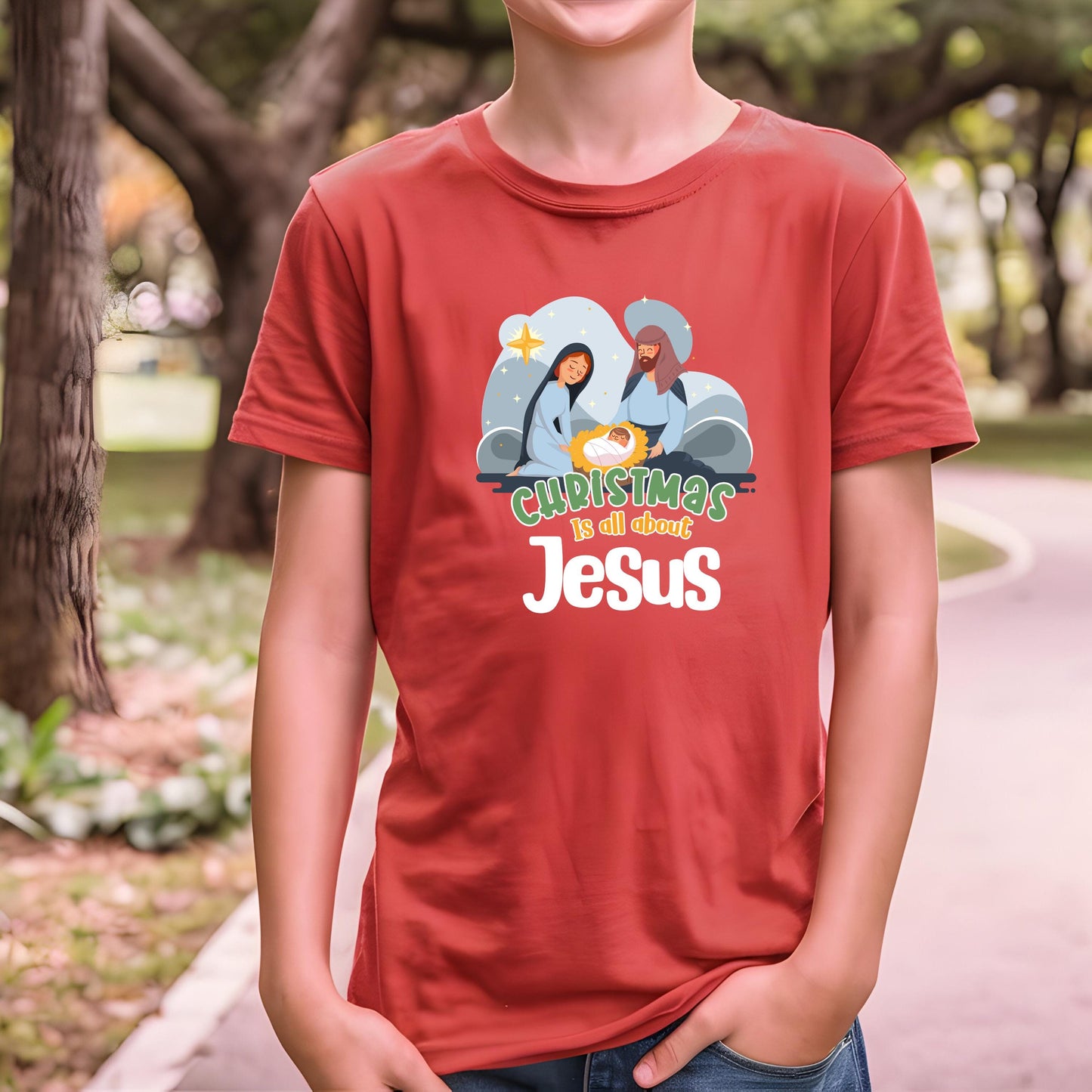 Close-up of Christmas Is All About Jesus Kids Shirt with festive Christian design in Heather Red.