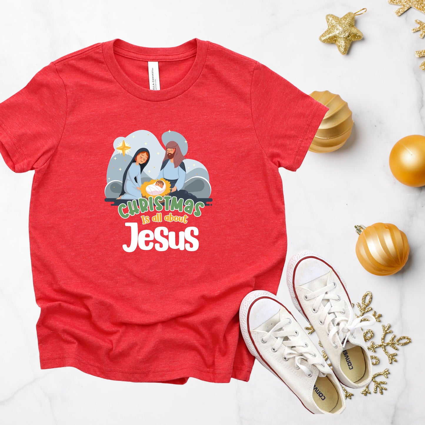 Close-up of Christmas Is All About Jesus Kids Shirt with festive Christian design in Heather Red