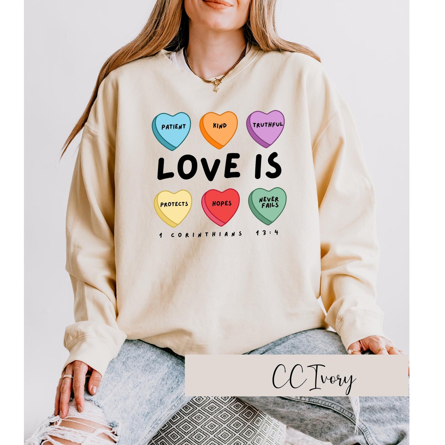 Celebrate love and faith with our Candy Hearts 1 Corinthians 13 Valentine's Day Sweatshirt! Perfect for cozy winter days. Ivory Sweatshirt