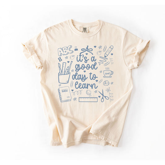 Beige t-shirt with blue educational graphics and text on a white background