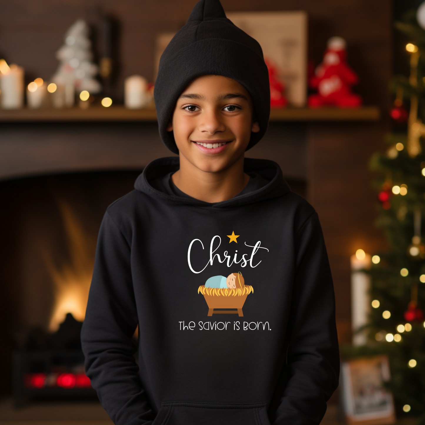 Child wearing a Christian Christmas sweatshirt with peaceful manger scene and holiday text