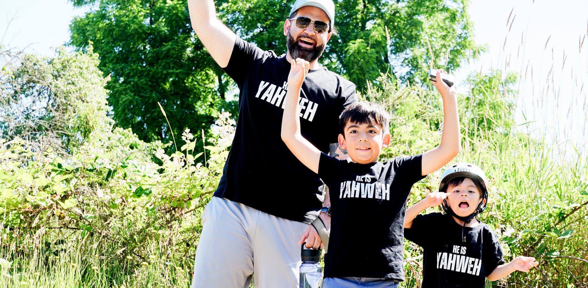 Black  crew t shirt that reads He is Yahweh, family photo,