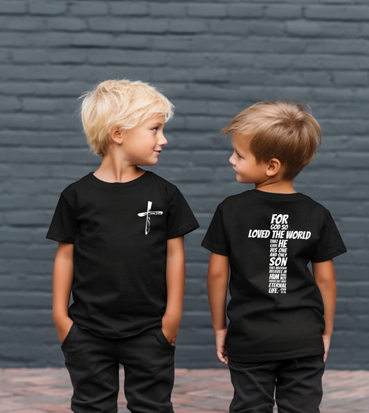 Two children wearing black t-shirts with text and a cross design, standing against a gray brick wall. bible verse John 3:16