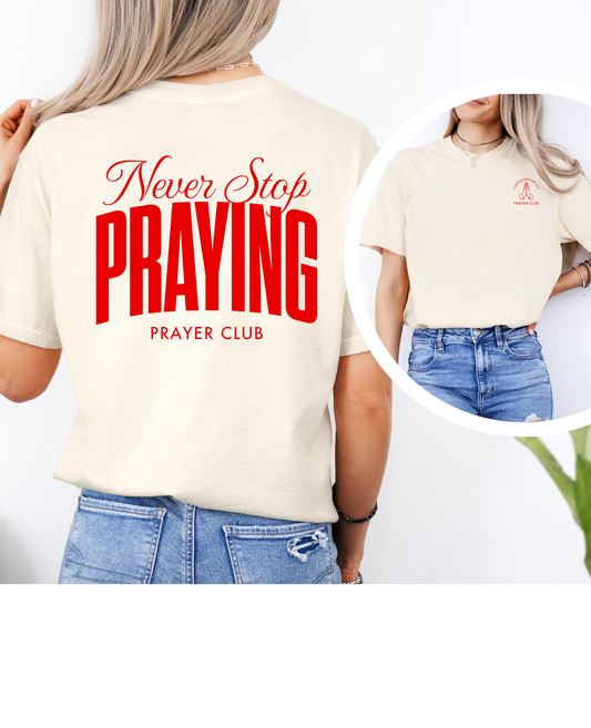 Woman wearing Never Stop Praying Christian shirt in Ecru on Red
Prayer Club graphic