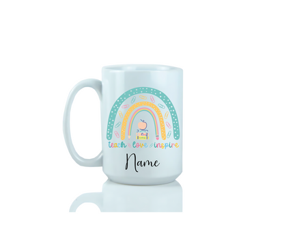 15oz White mug with a colorful design featuring a rainbow, cloud, and text that read teach, love, inspire.