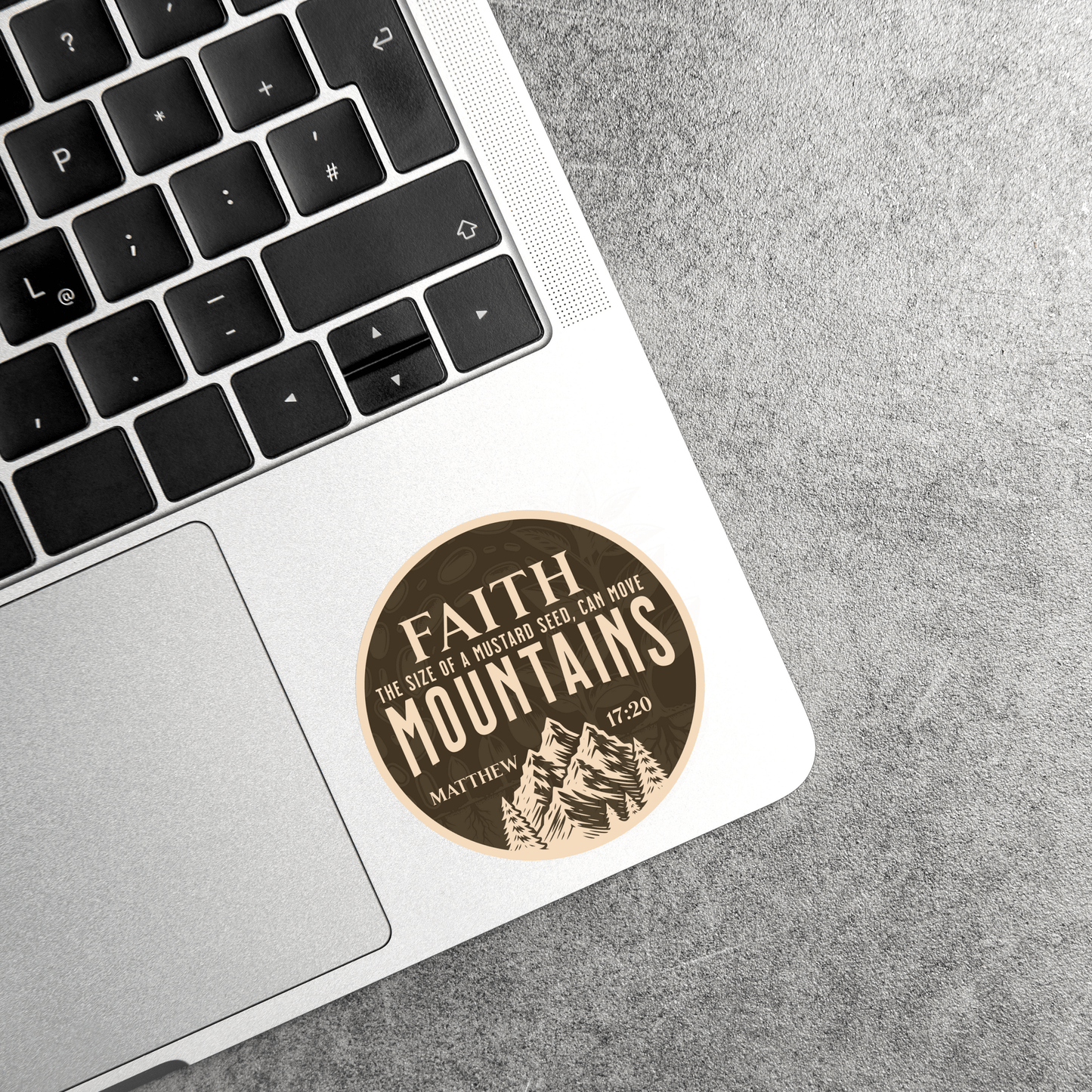 Faith Can Move Mountains waterproof sticker with Matthew 17:20 on a leather laptop