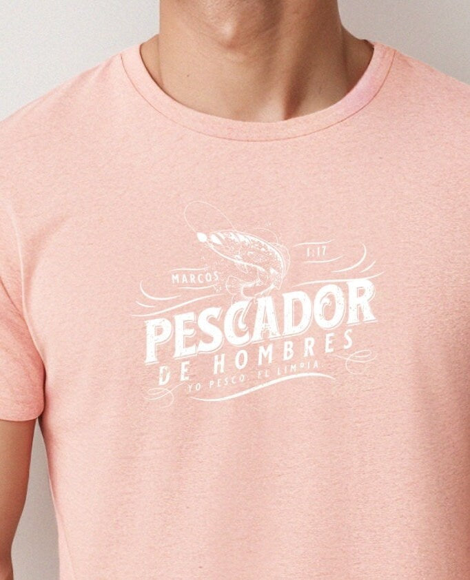 Man wearing Heather Sunset Christian t-shirt with ‘Pescador de Hombres’ design in Spanish, inspired by Mark 1:17 with a fishing hook graphic.
