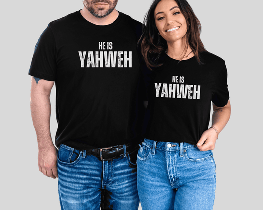 Smiling couple wearing matching black Christian t-shirts with bold white text that reads “He Is Yahweh,” styled for a modern faith-based look.