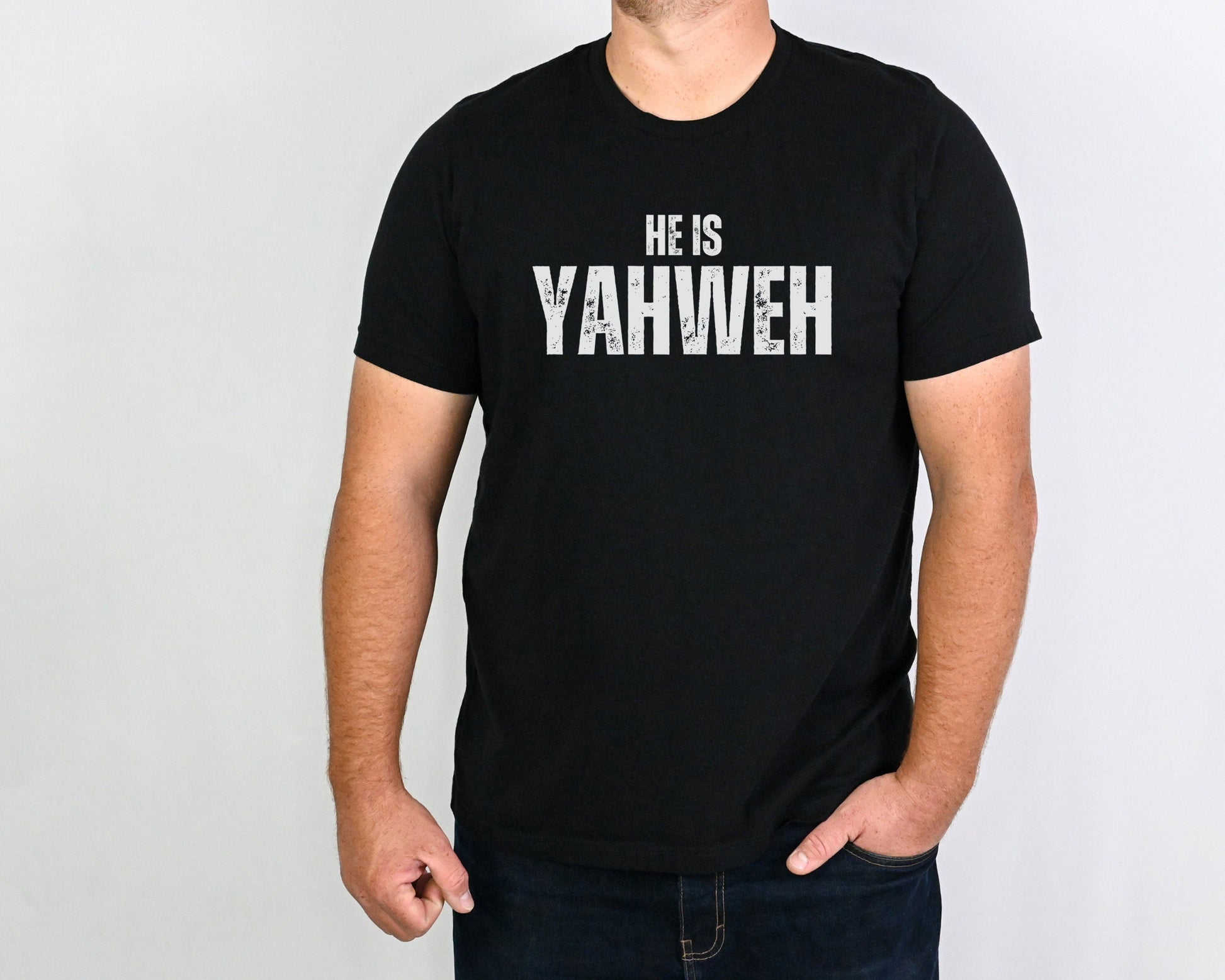 Men wearing  He Is Yahweh Shirt – Christian Unisex Tee in black with bold white text